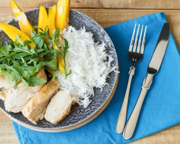Idealny posiłek po treningu: grillowany kurczak, ryż, mango i rukola. Zdrowo i smacznie!